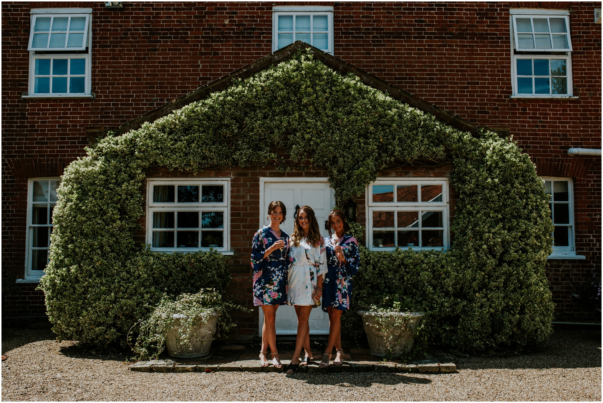 bride and bridesmaids wearing dressing gowns at the barn at woodlands norfolk