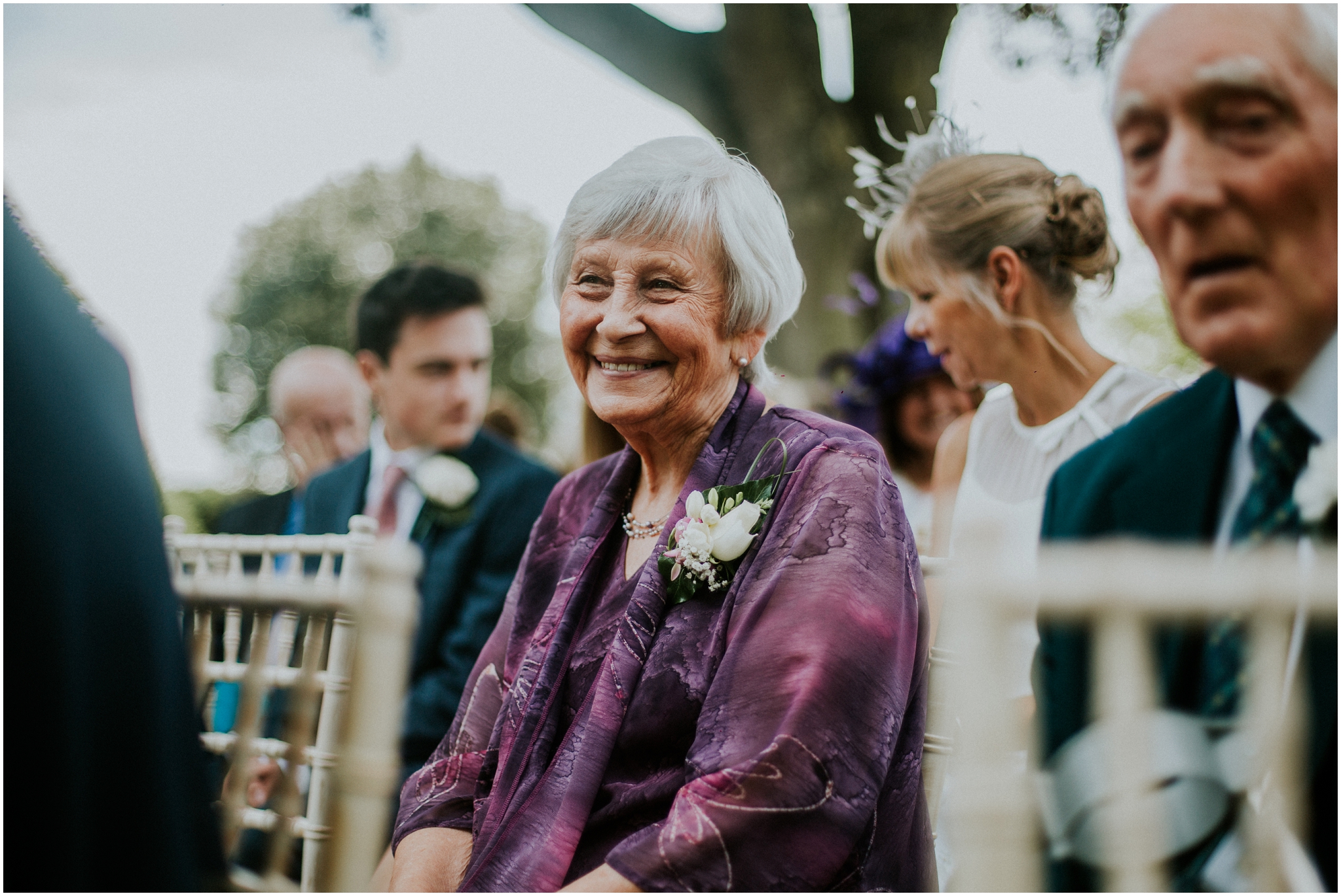 grandmother smiling at outdoor wedding ceremony
