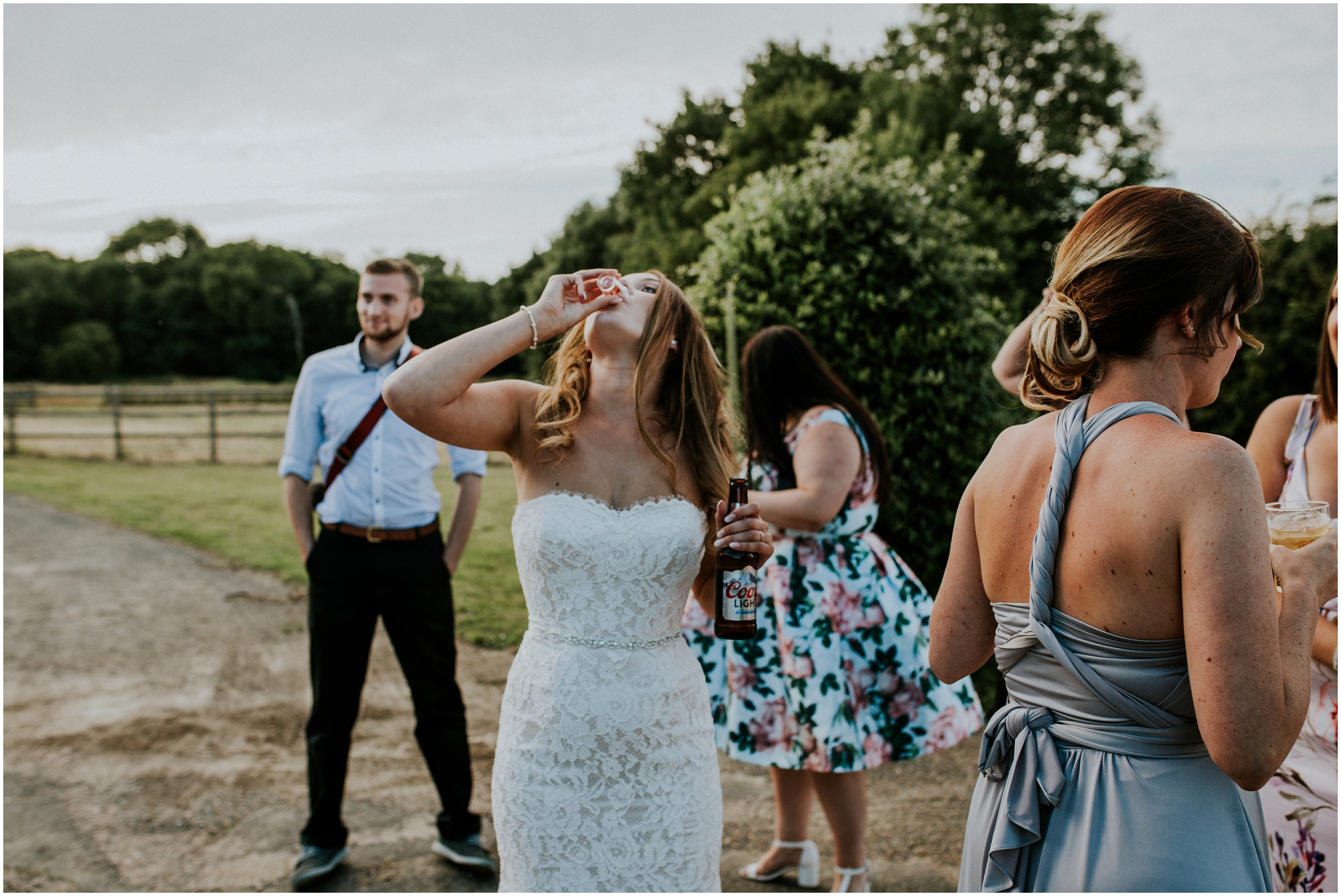 super cool bride doing a shot while holding a beer
