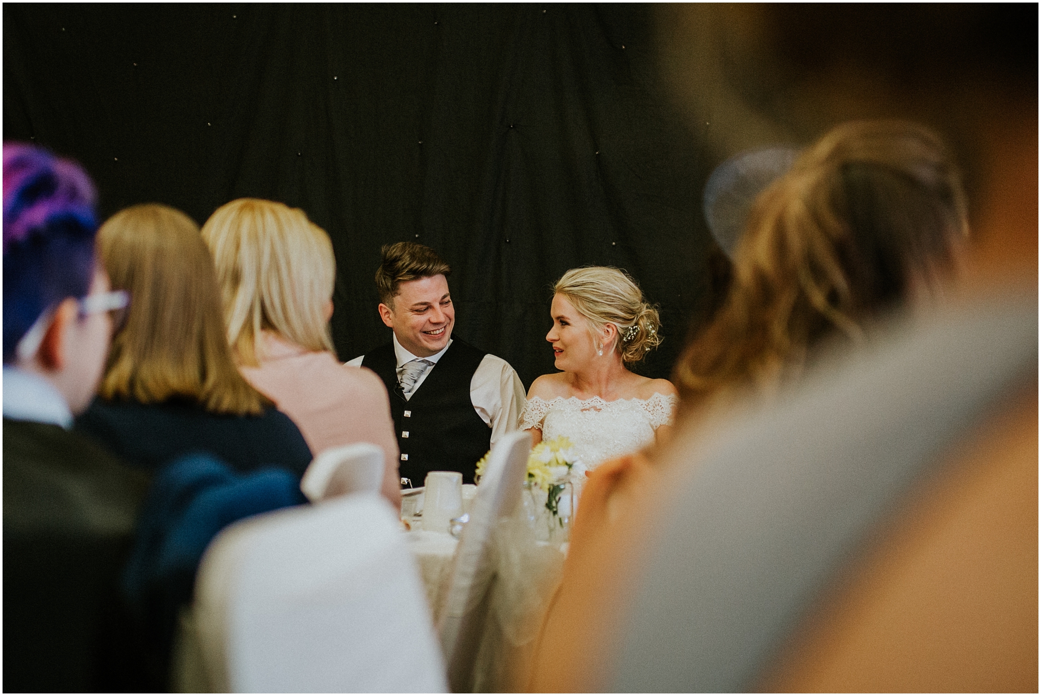 bride and groom looking at each other laughing