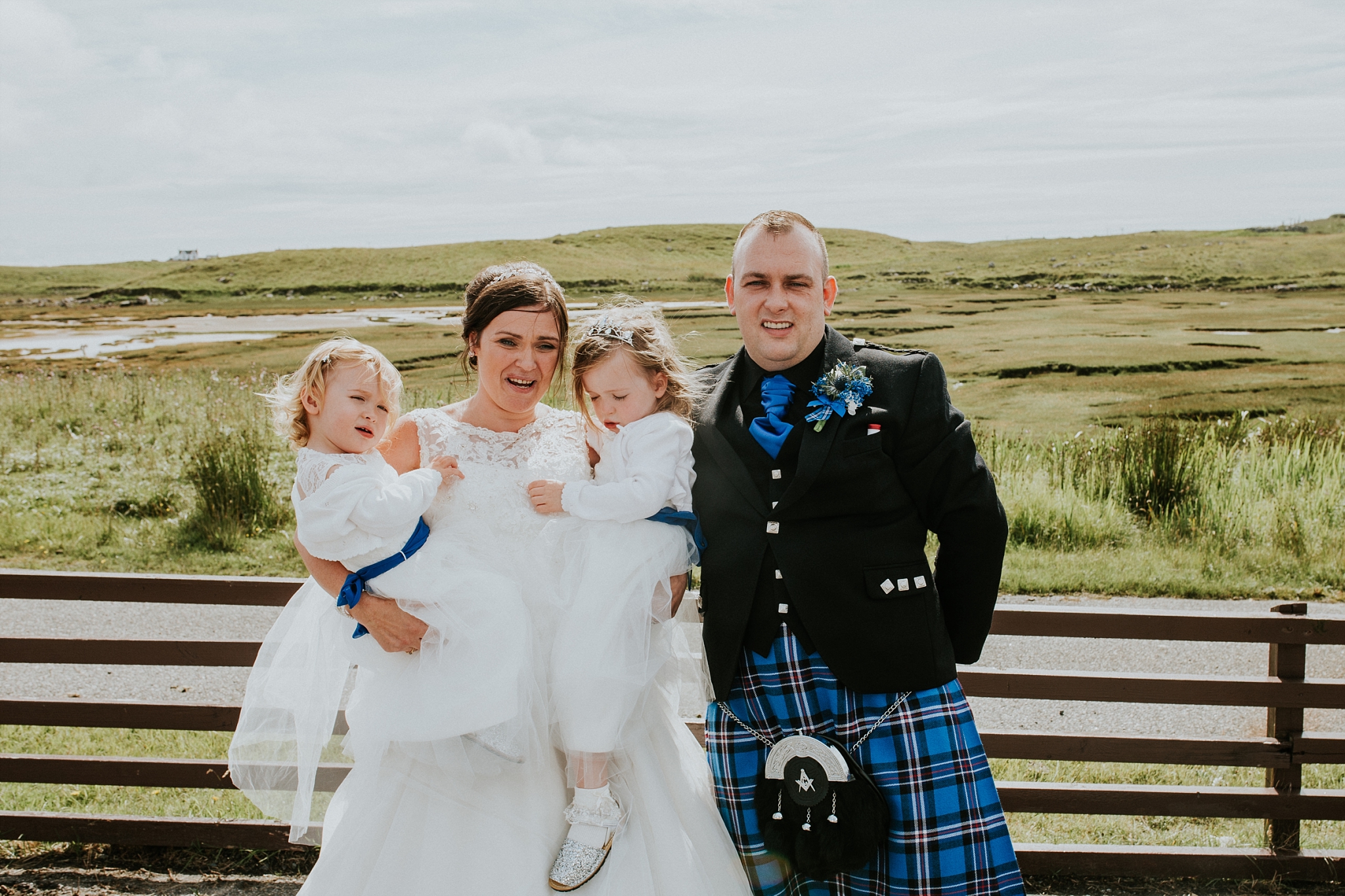 bride and groom with two flower girls, family photo