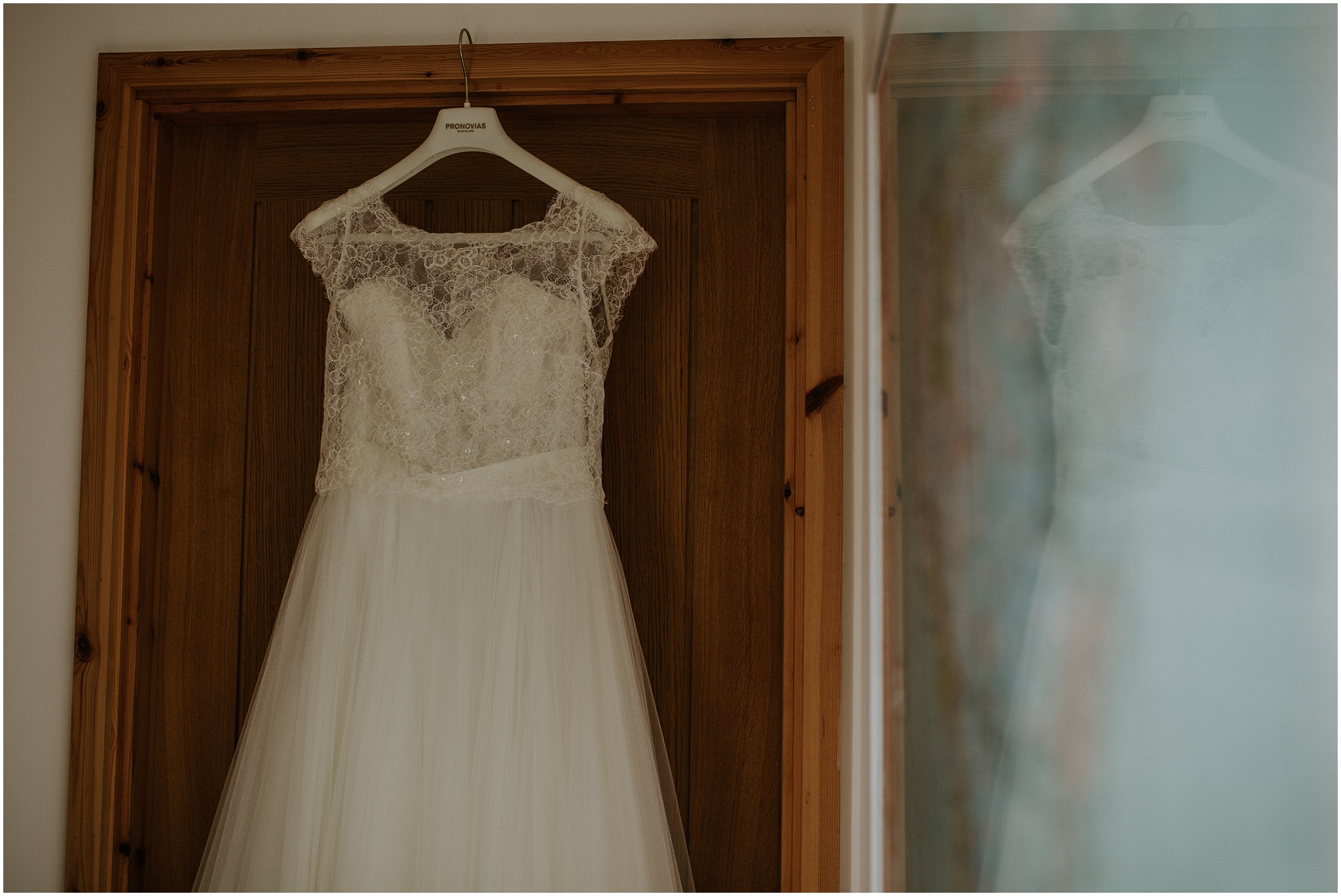 wedding dress hanging up in doorway