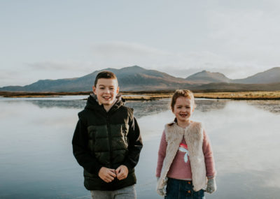 Brother and Sister standing in front of a frozen loch on the Isle of South Uist