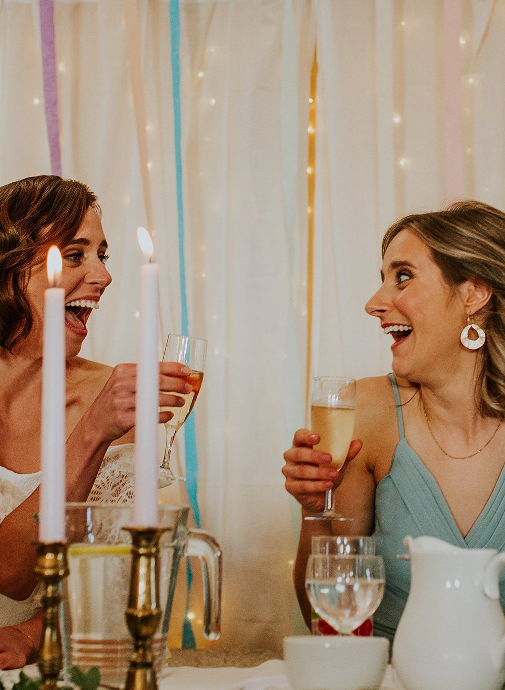 Bride and bridesmaid celebrating during speeches at a north uist wedding